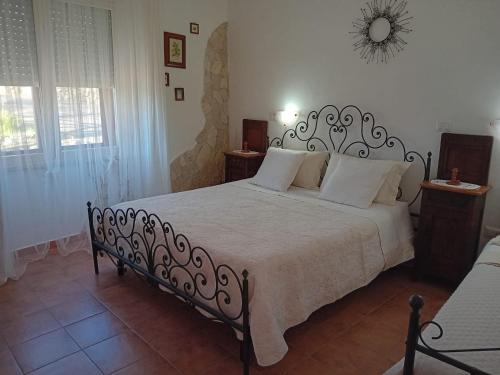 a bedroom with a large bed with white pillows at Belli come il Sole in Serri