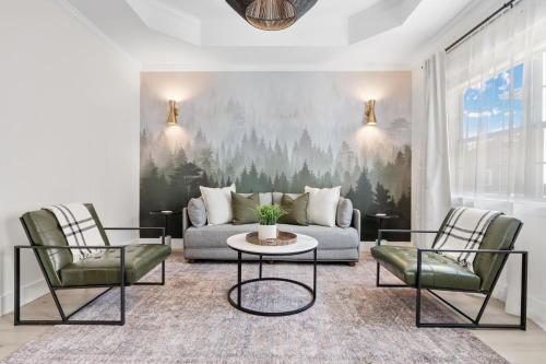 a living room with a couch and two chairs at 27 on Park Boutique Hotel & Venue in Dahlonega