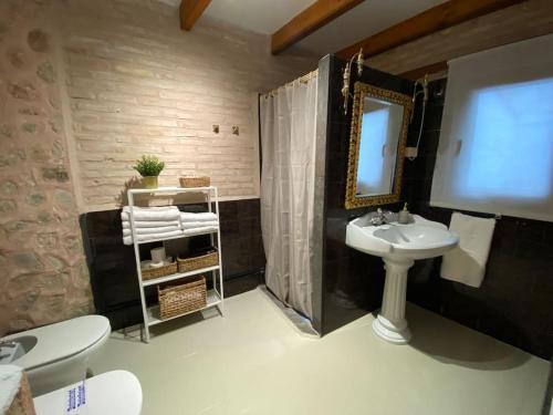 a bathroom with a sink and a mirror at Apartamentos Ca Federo, Casa la Tía Elena 