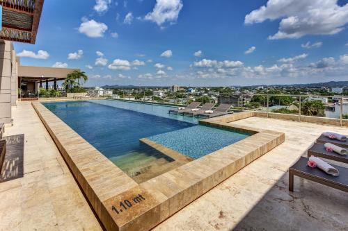 a swimming pool on top of a building at GHL Hotel Monteria in Monter&iacute;a