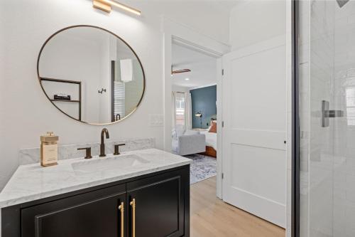 a bathroom with a sink and a mirror at 27 on Park Boutique Hotel & Venue in Dahlonega
