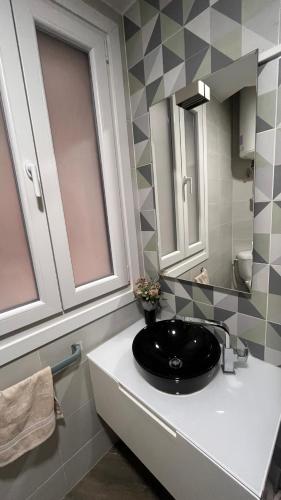 a bathroom with a black sink and a mirror at La de Fredyy - Tres Marias Apartments in Redondela