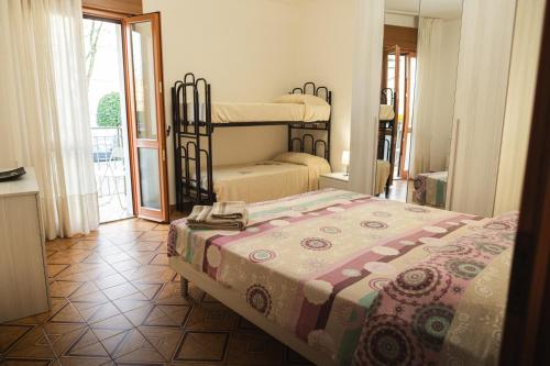 a bedroom with two bunk beds and a balcony at CasaDilva in Chioggia