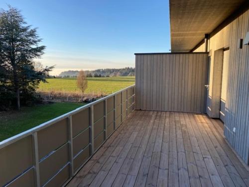a deck with a fence and a building at Ferienwohnung Bodenseeblick Nr 8 in Scheidegg