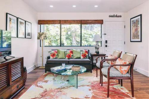 a living room with a couch and a table at Hale Ho'okipa in Volcano