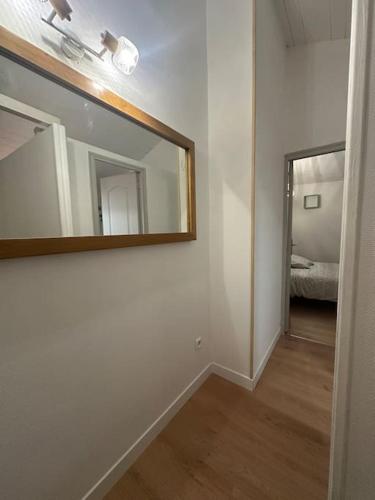 a white room with a mirror and a bedroom at Appartement F2 cosy en duplex Hyper Centre Bourgogne in Orléans