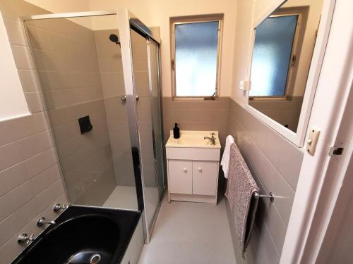 a bathroom with a sink and a shower at The Winemakers Quarters in Tanunda