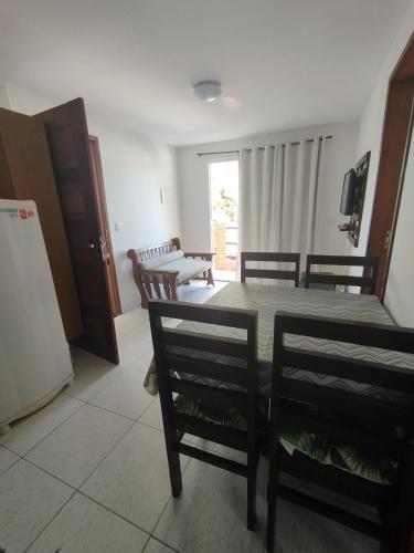 a living room with a dining room table and chairs at Residencial Fran Chiattone in Natal