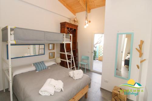 a bedroom with a bunk bed and a mirror at Acquamarina B&Beach in Follonica