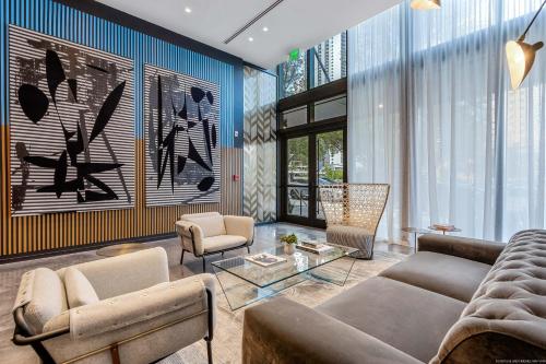 a living room with a couch and a table at Bayside Luxury: Studio Near Bayfront Park in Miami