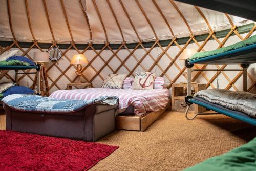 a bedroom with a bed in a yurt at The Grove Glamping in Cromer