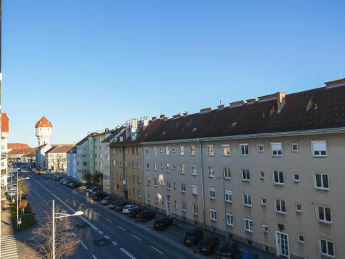 a city street with buildings and a water tower at Spacious Apartments with View & Free Parking in Wiener Neustadt
