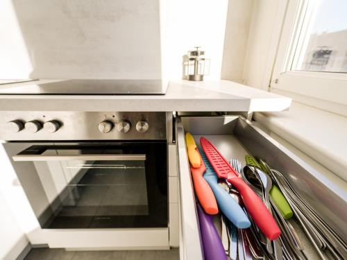 a drawer in a kitchen with colorful utensils at Spacious Apartments with View & Free Parking in Wiener Neustadt