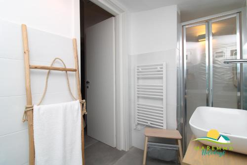 a bathroom with a sink and a bath tub at Acquamarina B&Beach in Follonica