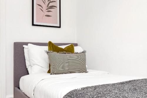 a bedroom with a bed with a yellow pillow at NEW Lily House by Truestays - 3 Bedroom House in Stoke-on-Trent in Newcastle under Lyme