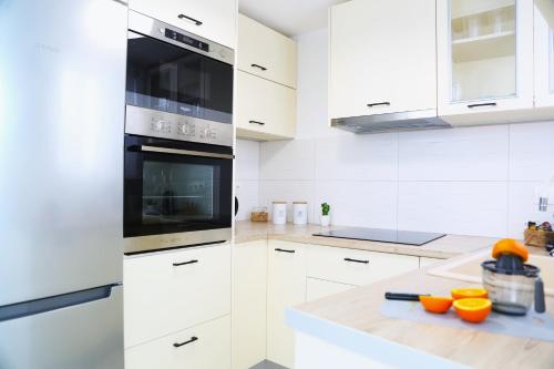 a white kitchen with white cabinets and an oven at Whitelist Lux Residence in Mykonos Town in Mýkonos City