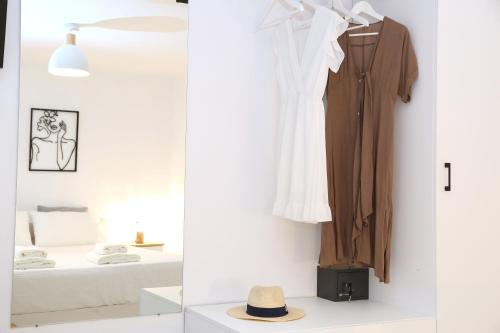 a room with a closet with a robe and a bed at Whitelist Lux Residence in Mykonos Town in Mýkonos City