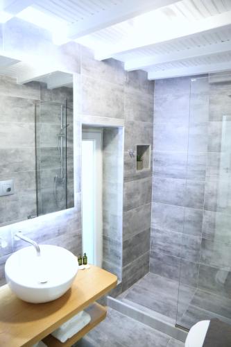 a bathroom with a sink and a shower at Whitelist Lux Residence in Mykonos Town in Mýkonos City