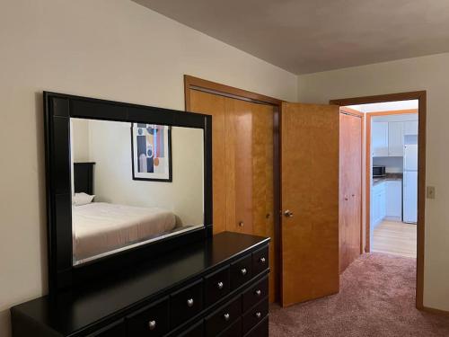 a bedroom with a mirror on top of a dresser at Entire apartment close to downtown - 2 queen beds in Springfield