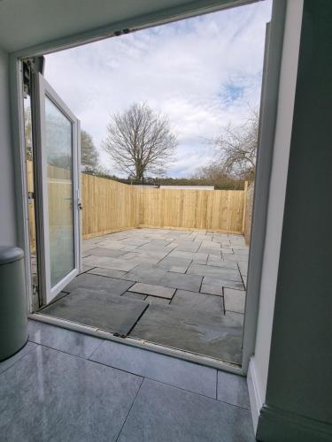 an open door to a patio with a fence at city centre - 2 bed house, parking for 2 in Cardiff