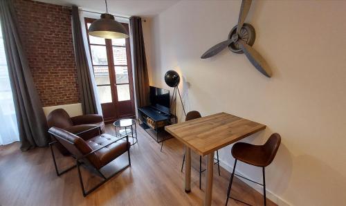 un salon avec une table et des chaises de salle à manger dans l'établissement Hyper centre de Grenoble, esprit industriel - fibre, à Grenoble