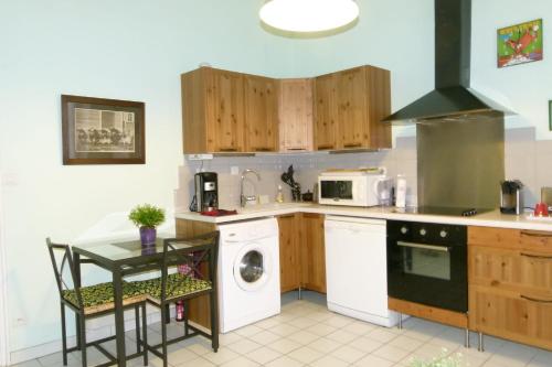 Charmant appartement 3 pers Perrache Confluence في ليون: مطبخ مع غسالة ملابس وغسالة صحون