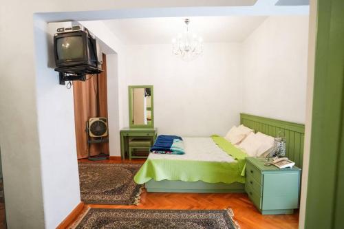 a bedroom with a bed and a tv in it at Amazing Flat 9 mins to Airport at Heliopolis in Cairo