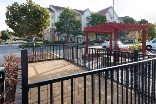 a black fence with a gazebo on a street at TownePlace Suites Milpitas Silicon Valley in Milpitas