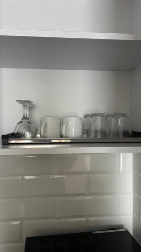 a shelf with bowls and glasses on it at ЖК «Сонячний квартал» in Solochin