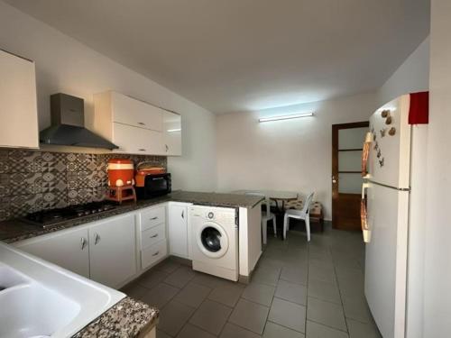 a kitchen with a washer and dryer in it at Villa S+3 Houmet Souk Djerba in Houmt Souk