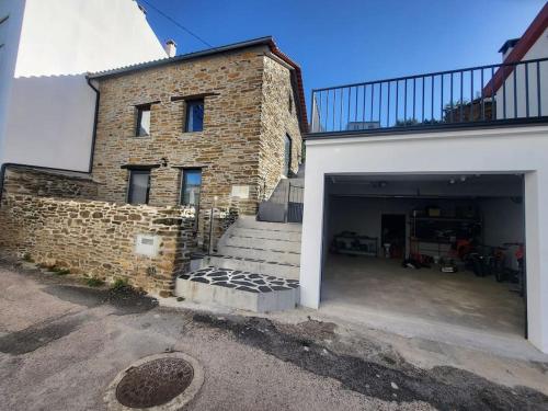 a large brick building with a garage and stairs at Da Silva house in Seia