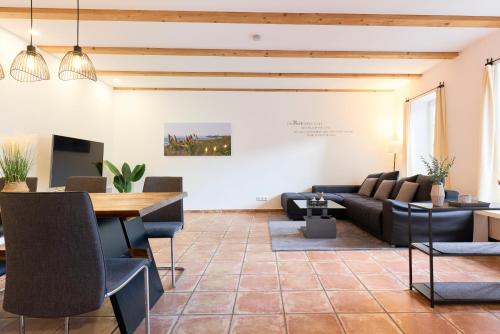 a living room with a couch and a table at Stilvolle Gartenterrassenwohnung mitten in Bregenz in Bregenz