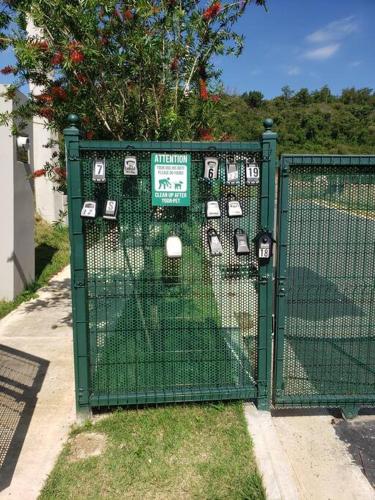 a green gate with a bunch of parking meters on it at Chalet The Palm Retreat Buye, Playa Buyé in El Cerro