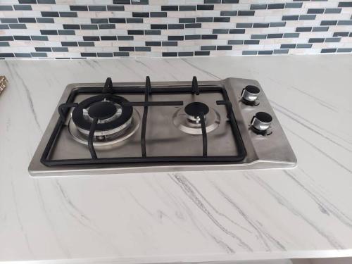 a stove top oven sitting on top of a counter at Chalet The Palm Retreat Buye, Playa Buyé in El Cerro