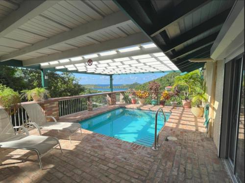 a swimming pool in a patio with at JJ's Getaway in Cruz Bay