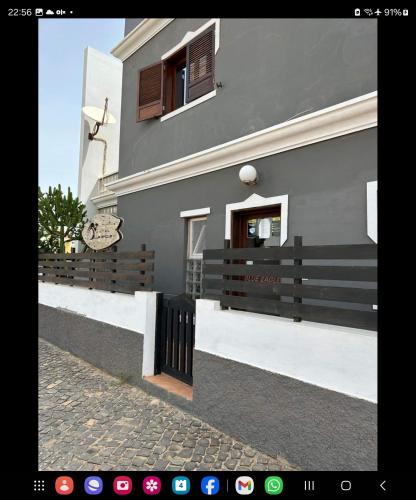 a house with a fence in front of it at Águia in Santa Maria