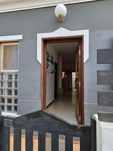 a hallway leading to a building with a door at Águia in Santa Maria