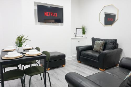 a living room with a table and a chair at Modern & Spacious, Central Location, FREE PARKING, FREE WIFI in Liverpool