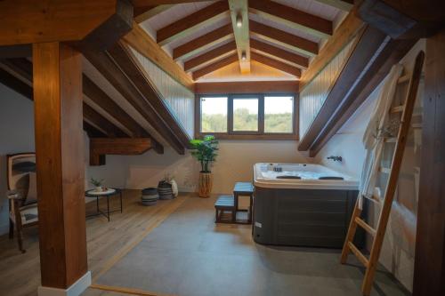 an attic kitchen with a sink and a counter at Casa Rural Kabia in Arráyoz