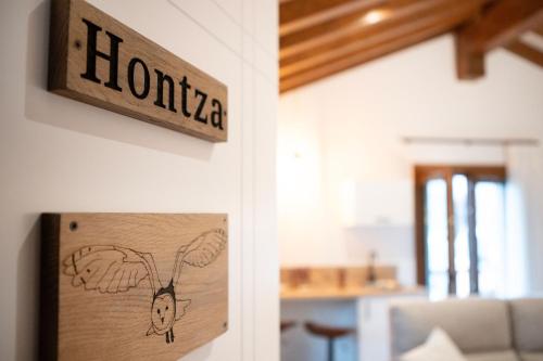a sign that says honda hanging on a wall at Casa Rural Kabia in Arráyoz