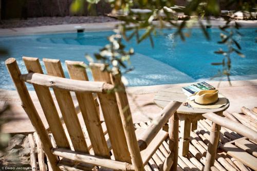 a hat sitting on a table next to a pool at L'Ma Lodge in Skoura