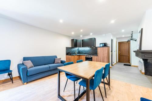 un salon avec un canapé bleu et une table dans l'établissement Appartement T2 