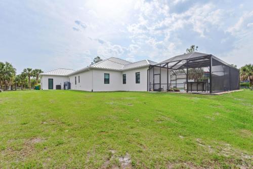 a large white house with a large yard at Eden's Endless Escape in Naples