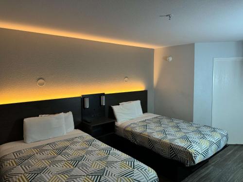 a hotel room with two beds in a room at Motel 6-Brownsville, TX in Brownsville