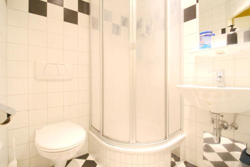 a bathroom with a shower and a toilet and a sink at Double Room in Hütteldorfer Straße Area in Vienna