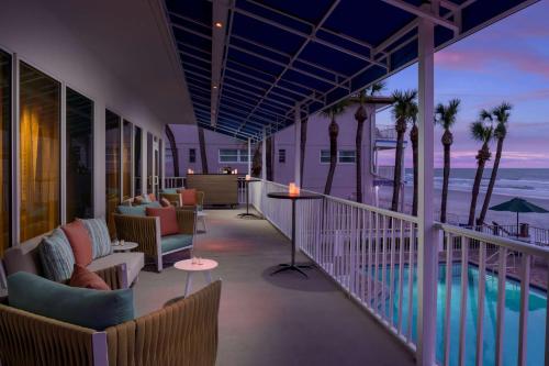 a balcony with chairs and a view of the ocean at DoubleTree Beach Resort by Hilton Tampa Bay – North Redington Beach in St Pete Beach