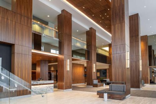 a lobby of a building with wooden columns at Hilton Vancouver Washington in Vancouver