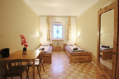 a room with a table and a room with a bed and a desk at Double Room in Hütteldorfer Straße Area in Vienna