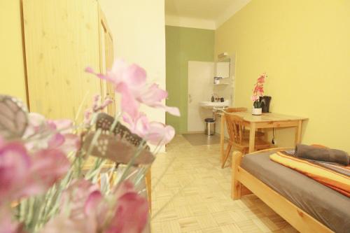 a room with a bed and a table with flowers at Double Room in Hütteldorfer Straße Area in Vienna
