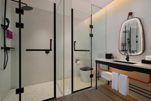 a bathroom with a sink and a mirror at Moxy Qiandao Lake in Chun'an